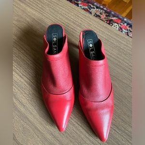 Red leather mules.